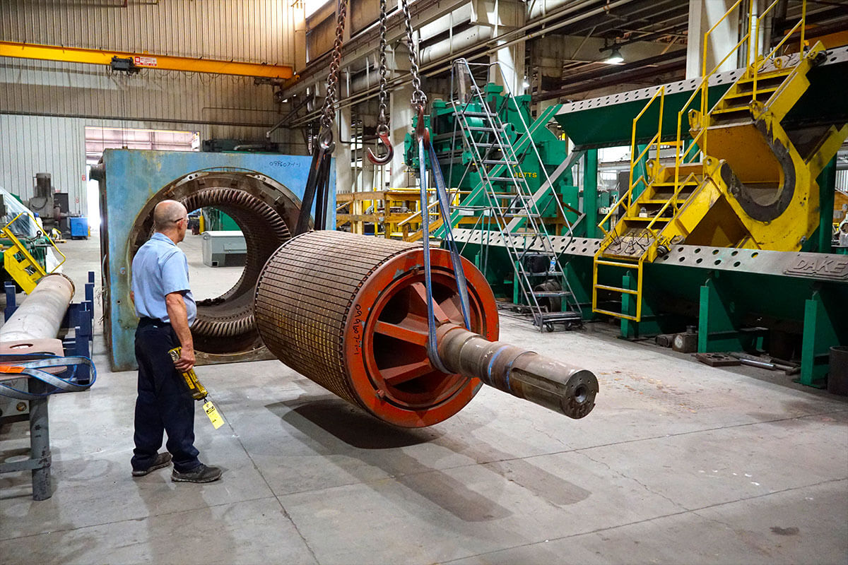 Smith Services repairing large scale generator with crane